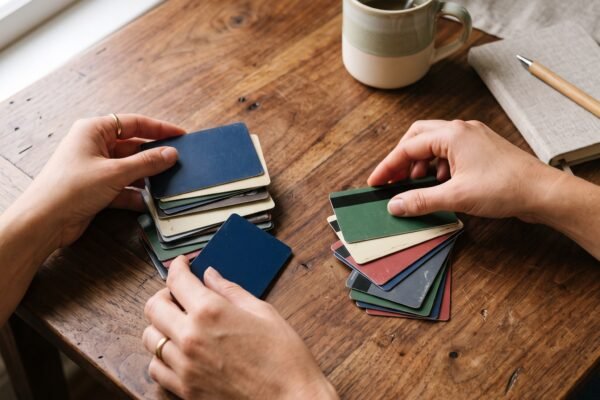 Hands sorting credit cards into groups to plan a debt snowball payoff order
